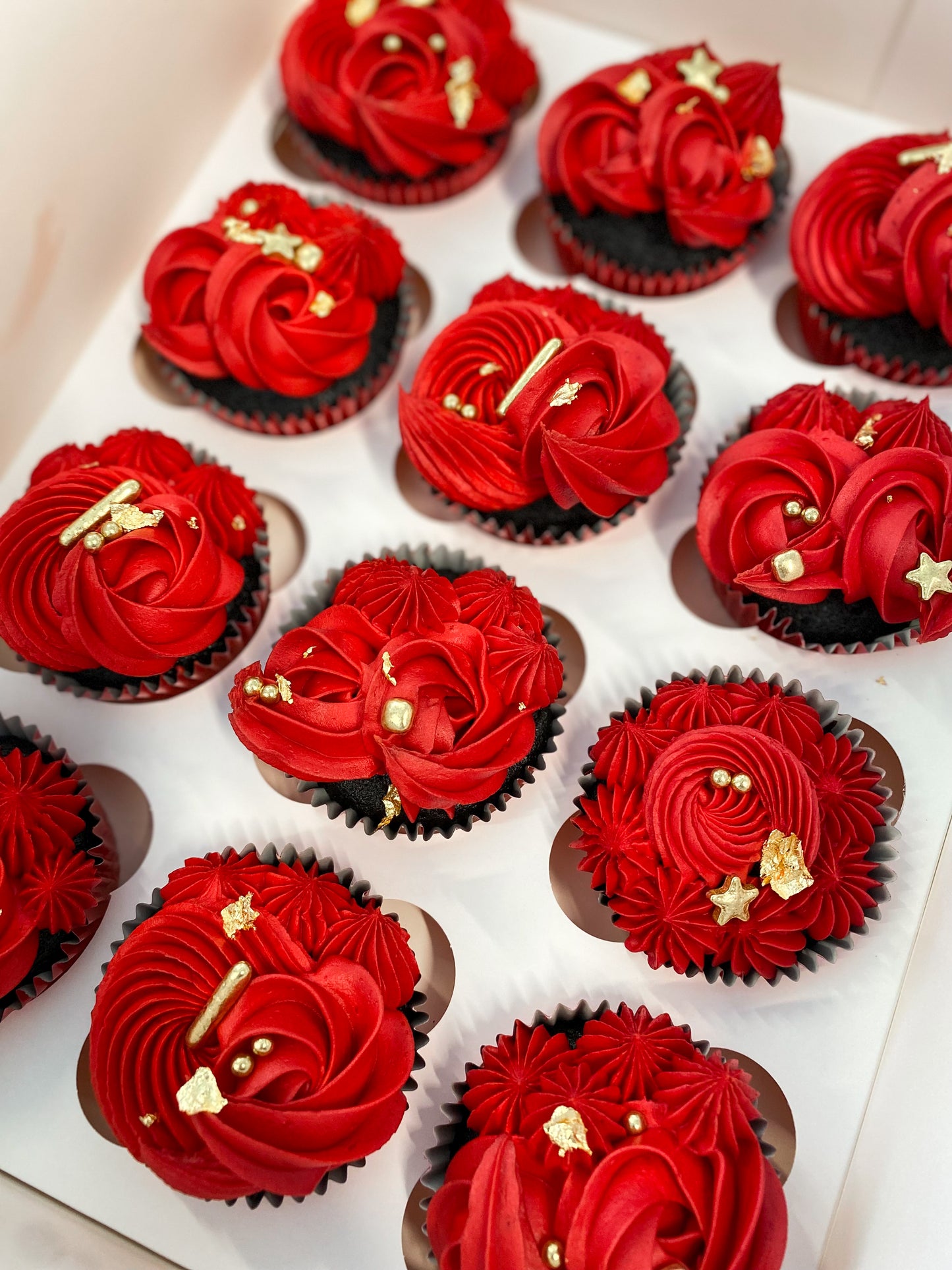 Red cupcakes with gold sprinkles