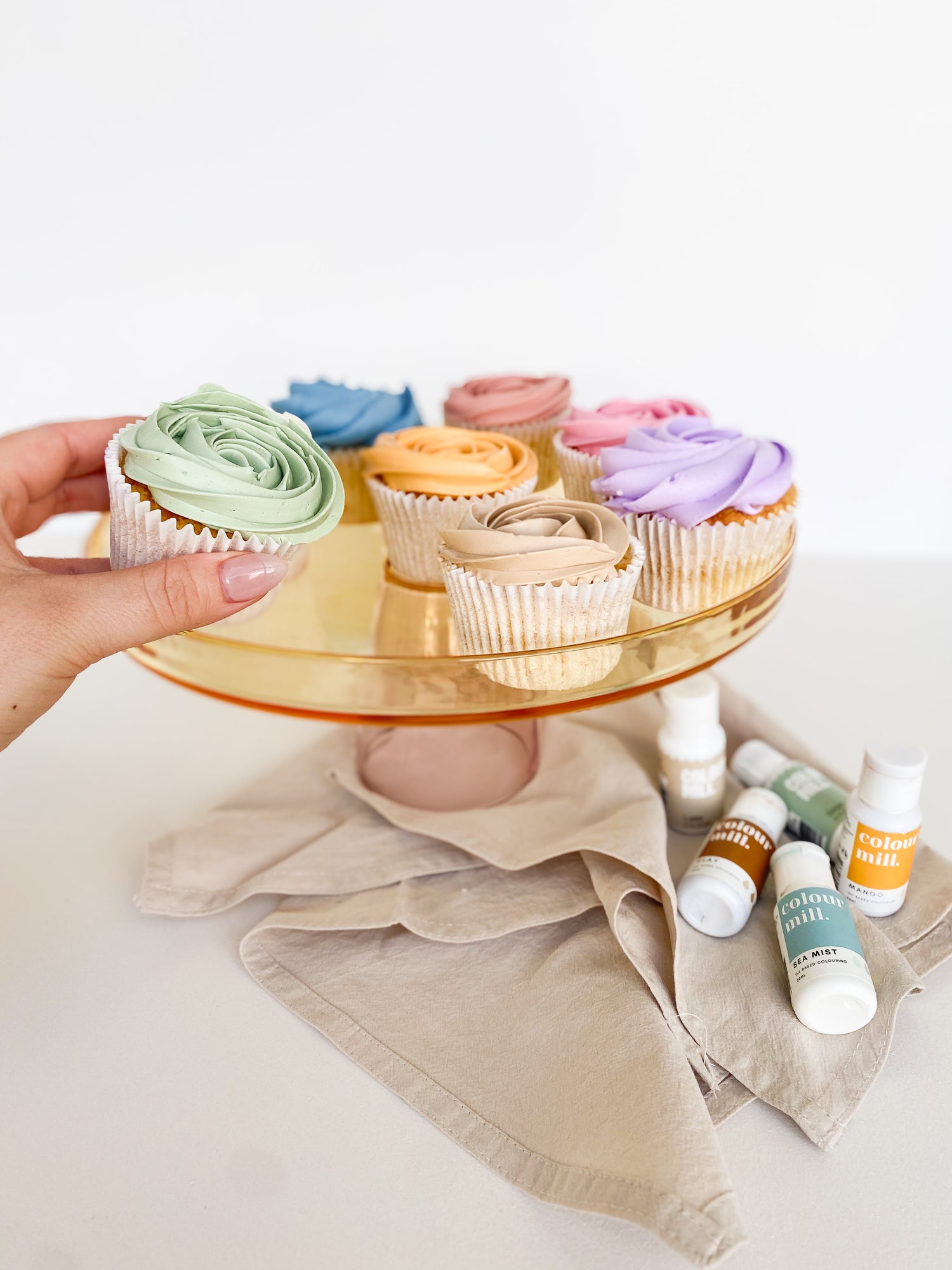 multicoloured cupcakes on a cake stand