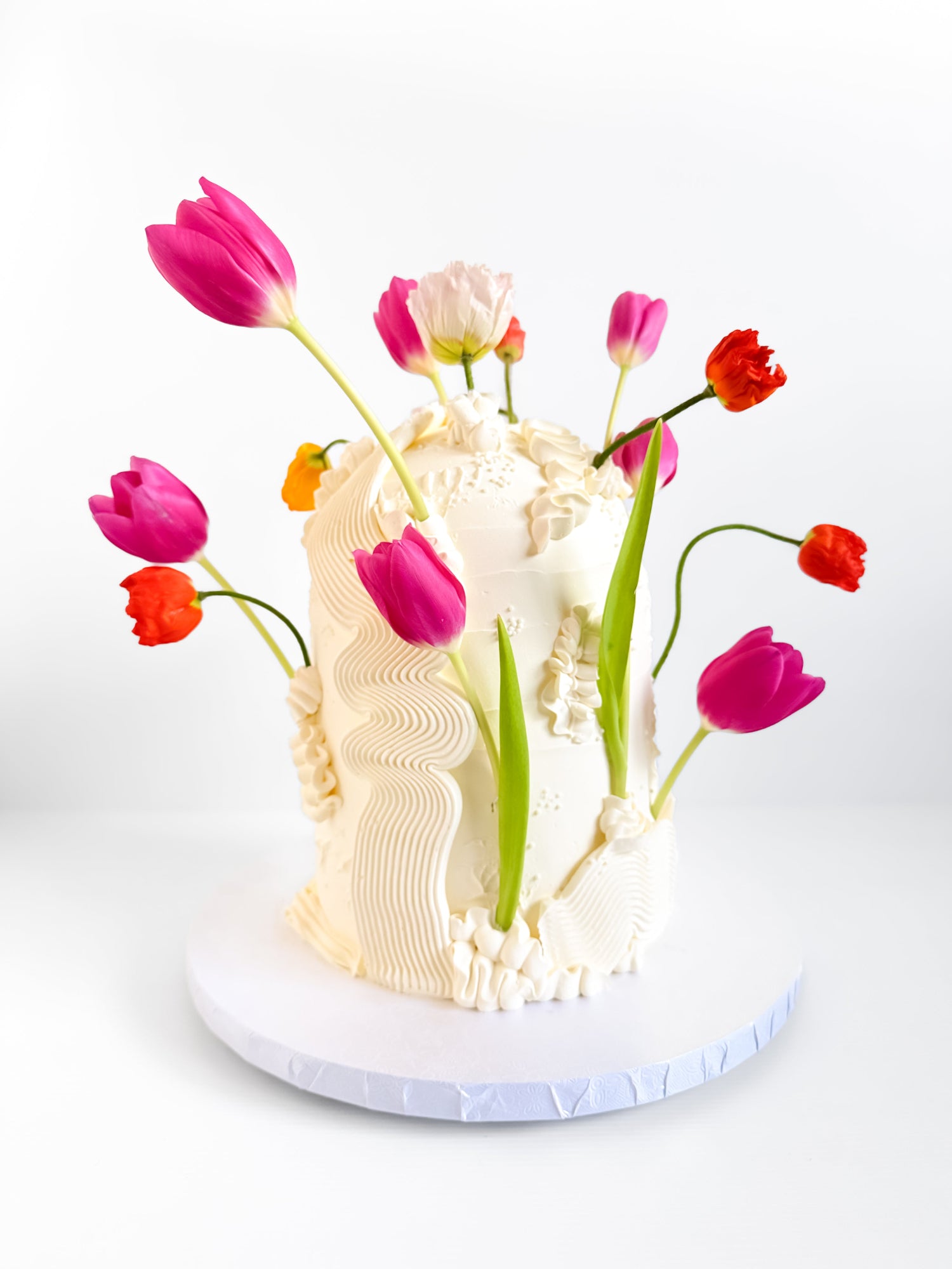 Decorative cake with tulips on a white background