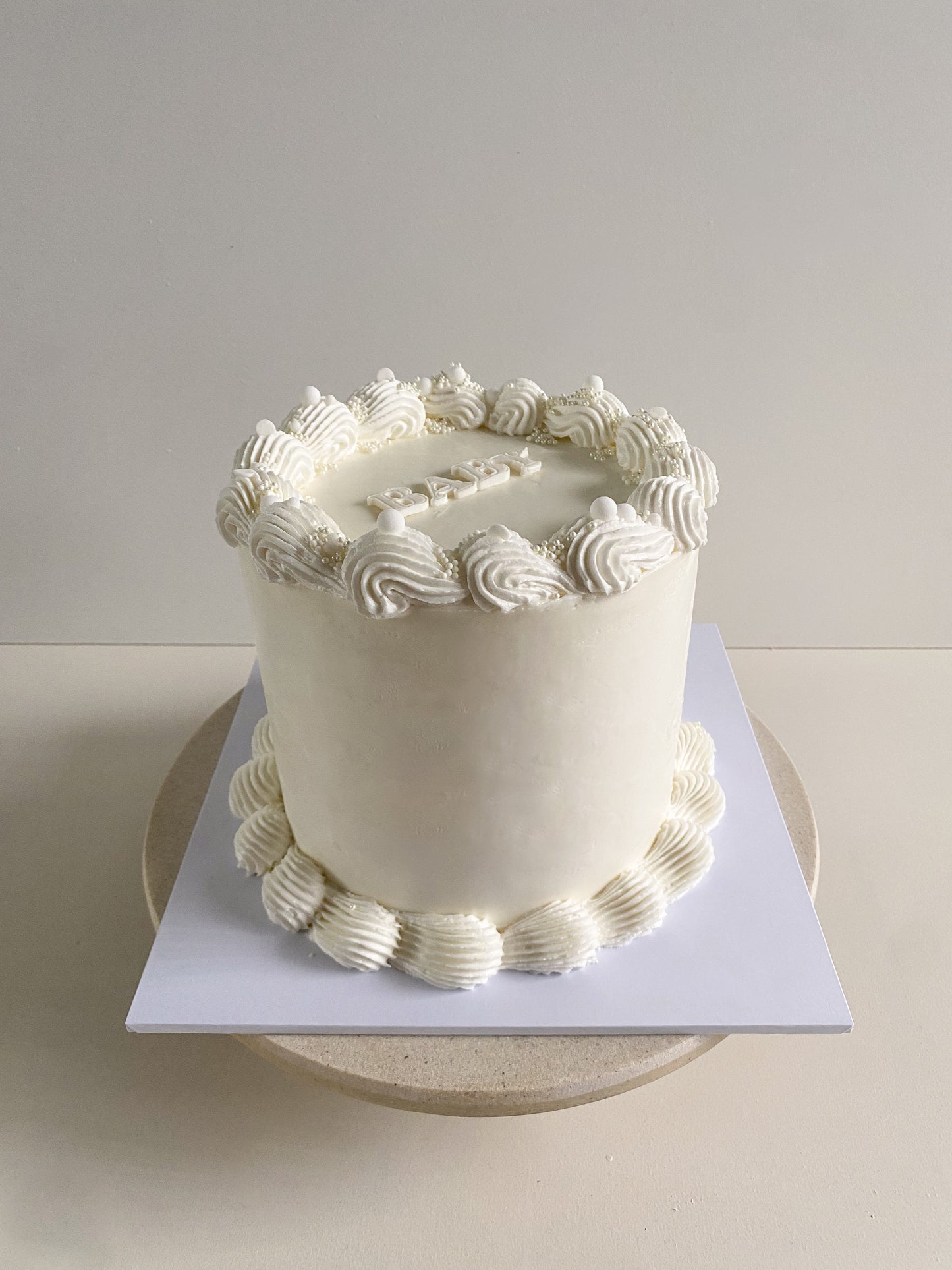White Gender Reveal Cake front on